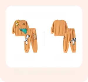 Flat lay of boys safari cotton tracksuit featuring lion and crocodile cartoon prints