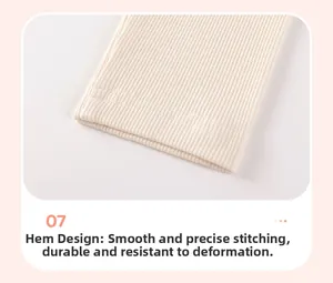 Close-up of ribbed texture and double-stitched hem on cream white knit trousers