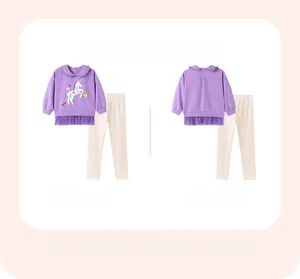 Detail of girl's purple sweatshirt featuring unicorn embroidery and tulle hem details