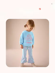 Detail of girls' blue sweatshirt with turtle print and striped flare pants set