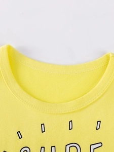 Close-up of a yellow cotton t-shirt with a round neck and artistic letter print