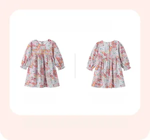 Front and back view of long-sleeved floral cotton dress for girls with ruffle cuffs
