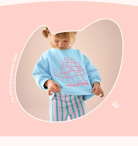 Detail of blue cotton toddler set featuring a turtle print sweatshirt and striped pants