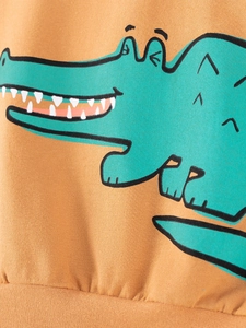 Kids long sleeve sweatshirt in ginger yellow with green cartoon crocodile print