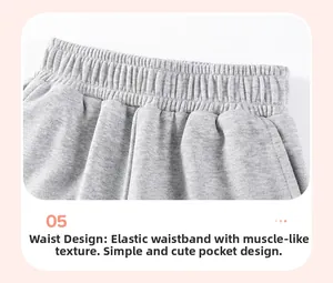 Detail of elastic waistband and side pockets on grey cotton knit shorts for boys