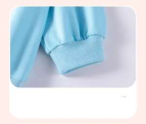 Close-up of tight ribbed cuffs on sky blue striped cotton sweatshirt for toddler girls
