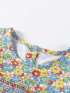 Girls' cotton autumn dress with colorful floral patterns and smocking craft detail