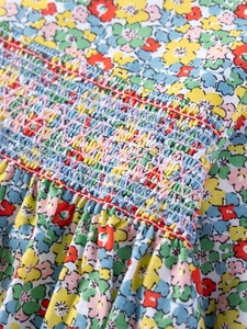 Girl cotton dress with colorful floral print and detailed smocking chest embroidery