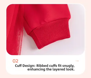 Detail view of the elastic ribbed cuffs on a red long-sleeved dress with tulle mesh fabric