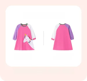Detail of pink long-sleeved girl dress with unicorn applique and purple contrast sleeves
