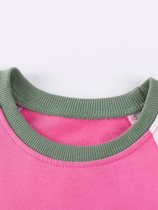 Pink girls' sweatshirt with green ribbed collar and premium crewneck stitching details