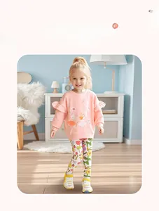 Detail of girls' pink ruffle sweatshirt with rabbit print and floral patterned leggings