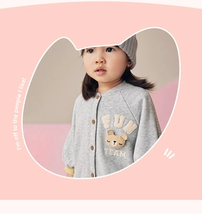 Detail of grey baby romper with cute 3D cartoon bear patch and button front closure