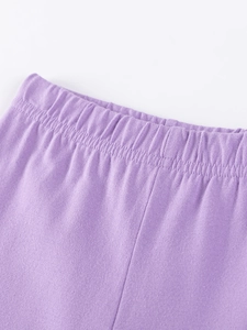 Detail of purple cotton knit kids' trousers featuring an elastic waistband and fine stitching