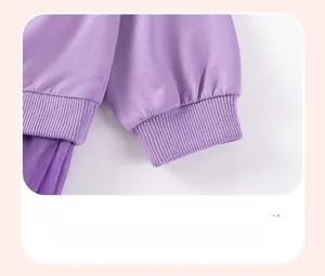 Detail view of purple ribbed cuffs and soft tulle patchwork on girl's cotton sweatshirt