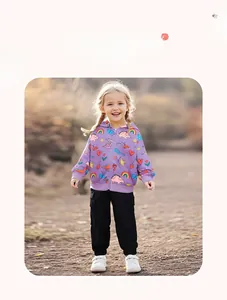 Outdoor shot of girls' purple zip-up hoodie with rainbow prints and black cargo pants