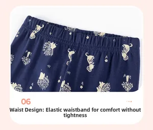 Detail view of navy blue girl's cotton leggings featuring elastic waistband and cat pattern