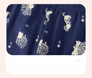 Detail of navy knit fabric featuring white hedgehog and floral discharge print patterns