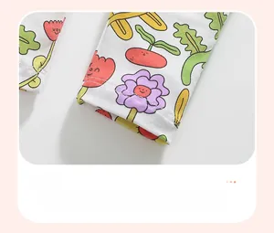 Detailed close-up of cotton kid's pants cuff with colorful cartoon floral print and stitching