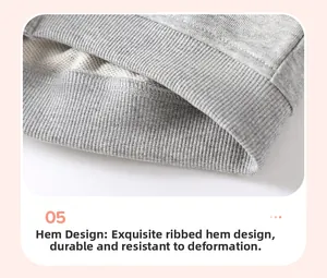 Detailed close-up of gray knitted sweatshirt with elastic ribbed hem and high texture