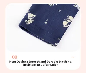 Detail of girls' navy cotton trousers featuring white cat print and smooth hem stitching