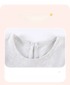 Detail of grey crew neck girl dress showing single needle double fold collar craftsmanship