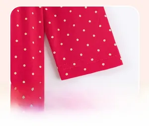 Detail shot of a red polka dot dress cuff featuring soft cotton knitted fabric