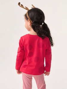 Tenue de Noël pour fille avec haut à pois rouges et pantalon rayé, vue de dos