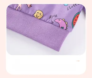 Detail of ribbed hem and cartoon dinosaur print on a purple hooded girl sweatshirt