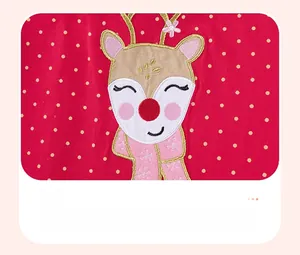 Detail of red knit fabric with yellow dots and cute reindeer embroidery for kids' dress