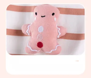 Detail of pink gingerbread man appliqué with embroidery on striped cotton fabric