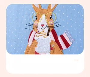 Detail of cartoon rabbit applique embroidery on light blue polka dot girls dress fabric
