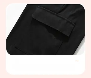 Detail of a large cargo pocket on a black cotton hoodie with neat stitching and flap