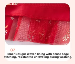 Detail of red Christmas dress lining with dense stitching and golden snowflake tulle mesh