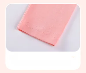 Detailed close-up of pink cotton leggings hem featuring durable flatlock double stitching