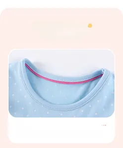 Detailed close-up of light blue polka dot cotton dress collar with pink inner lining