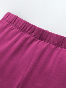 Girl's purple knit sports pants featuring a reinforced elastic waistband for comfort