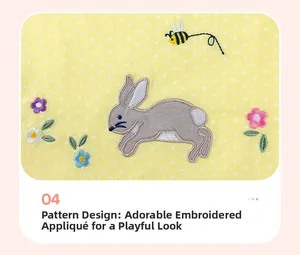 Détail de broderie appliquée lapin et abeille sur une robe jaune à pois pour enfant