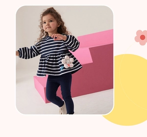 Detail of girl's navy striped long sleeve top with ruffle hem and matching blue leggings