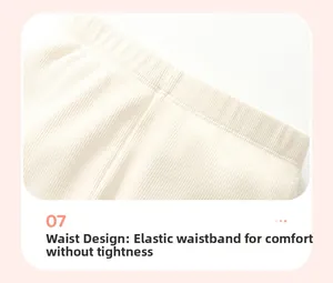 Detail of high-elastic waistband design on white ribbed knit long-sleeve toddler top
