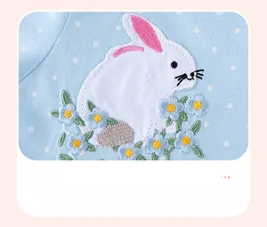 Detail of light blue cotton dress with white polka dots and bunny applique embroidery