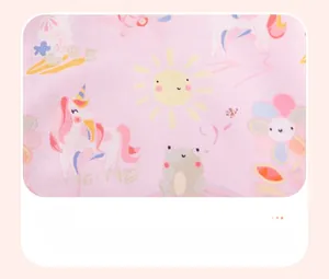 Nahaufnahme von rosa Baumwollstoff mit Einhorn- und Sonnendrucken für Kinderpullover