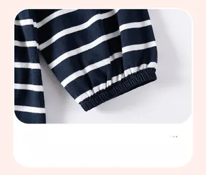 Close-up of elasticated cuffs on a navy blue and white striped knitted girls' sweater
