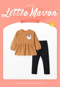 Detail of embroidered cat patch on a girls' orange polka dot ruffled sweatshirt