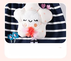 Detail of star applique with smile face and mesh bow on blue striped knit fabric