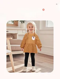 Detail showing toddler girl yellow polka dot top with cat patch and black leggings