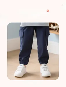 Detailed view of kids cargo pants in navy blue with cargo pockets and elastic cuffs