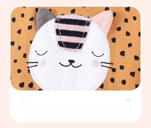 Detail of warm orange polka dot sweatshirt with cute cat fabric applique embroidery