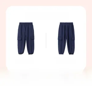 Detail view of navy cargo pants for boys with elastic waist and side flap pockets