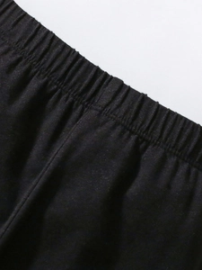 Girls black cotton sweatshirt featuring a wide elasticated waistband and knit texture